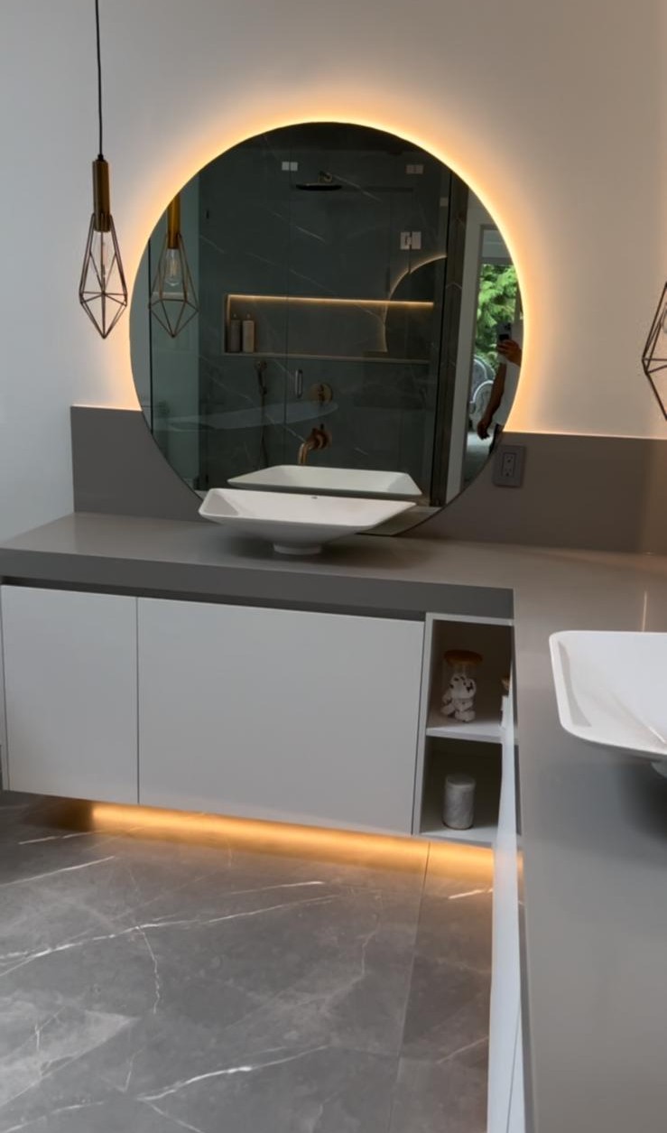 Vancouver powder room renovation with floating vanity, brushed brass fixtures and backlit oval mirror