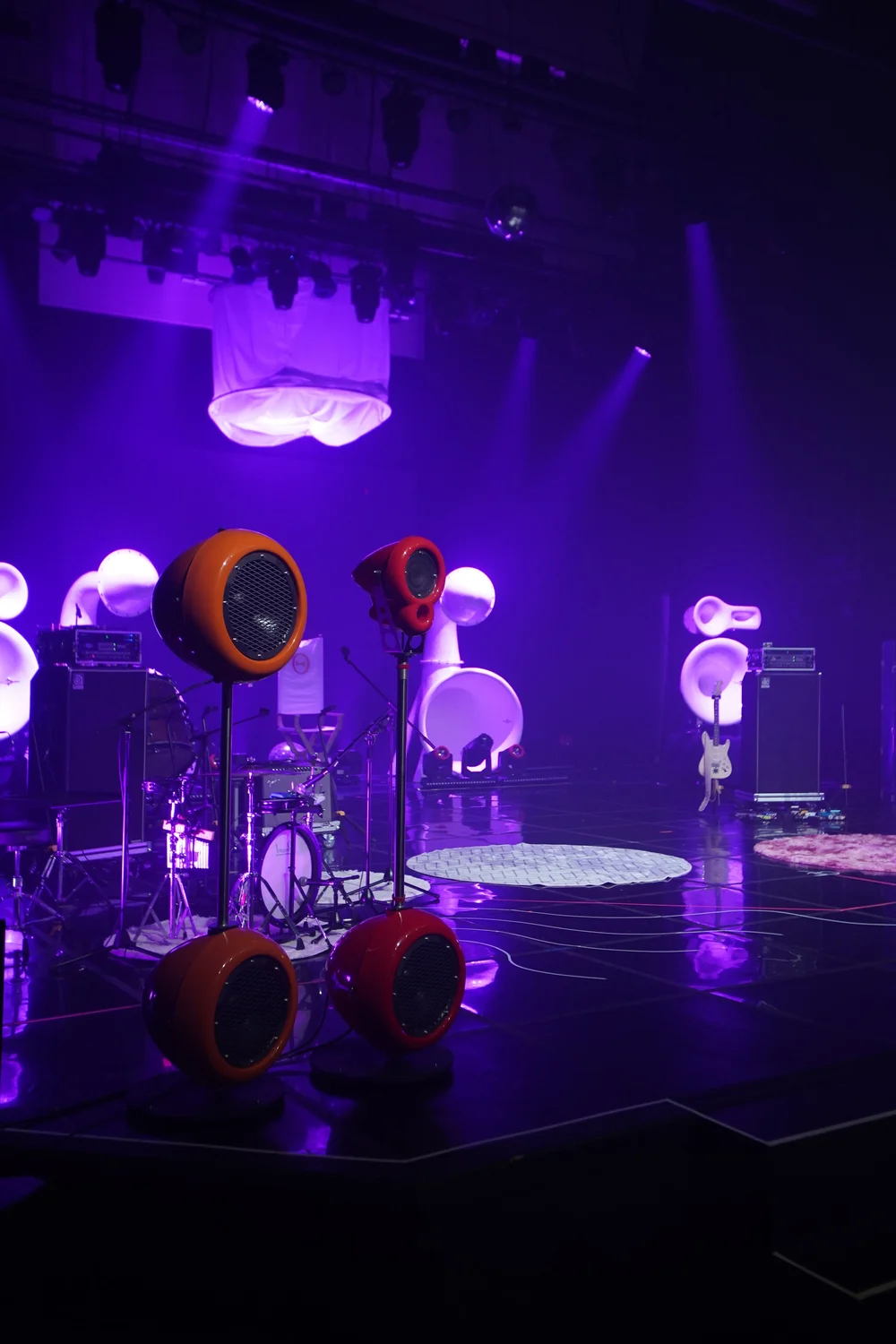 Concert stage with colorful Pequod speakers