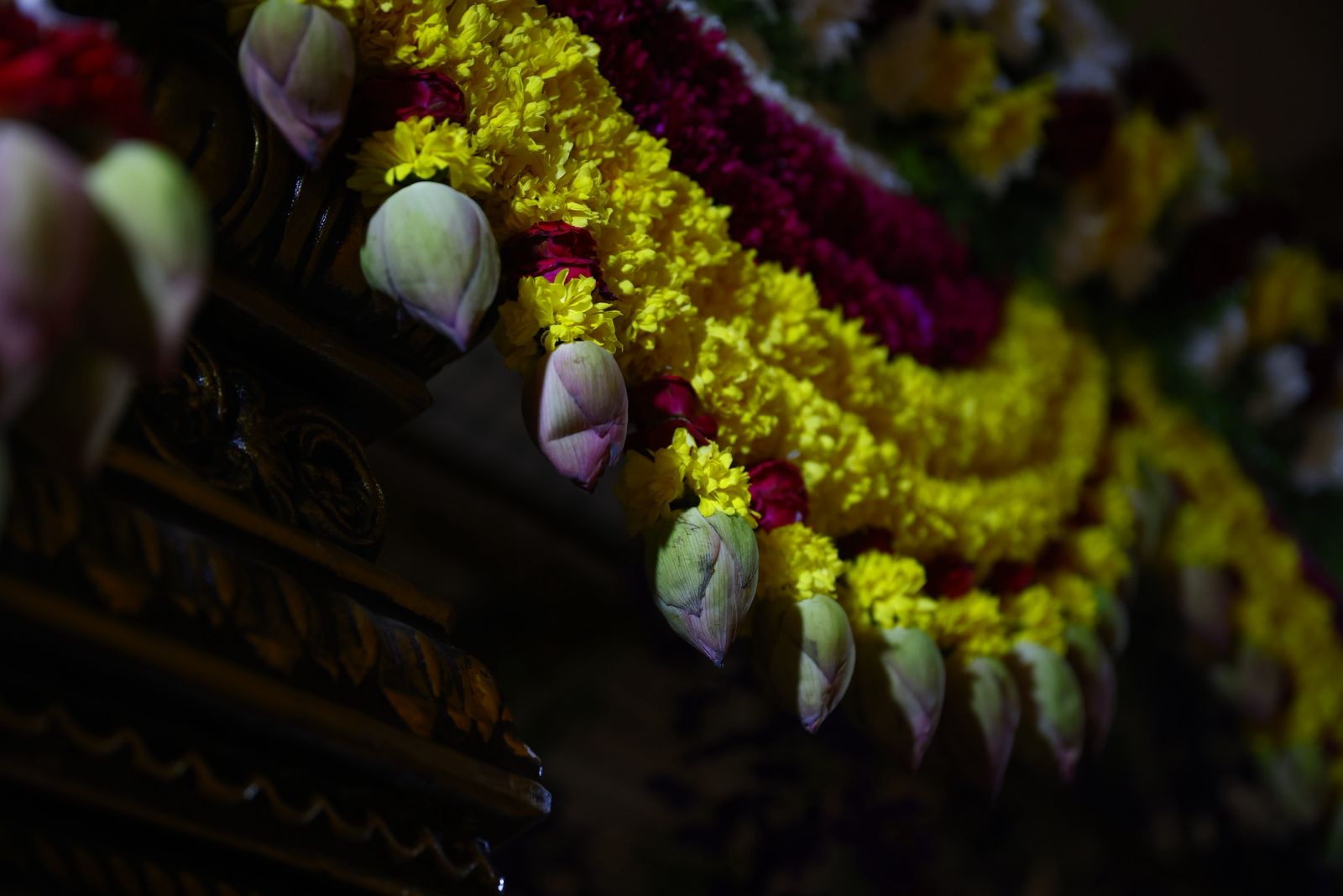 Close-up of marigold and lotus garland detail