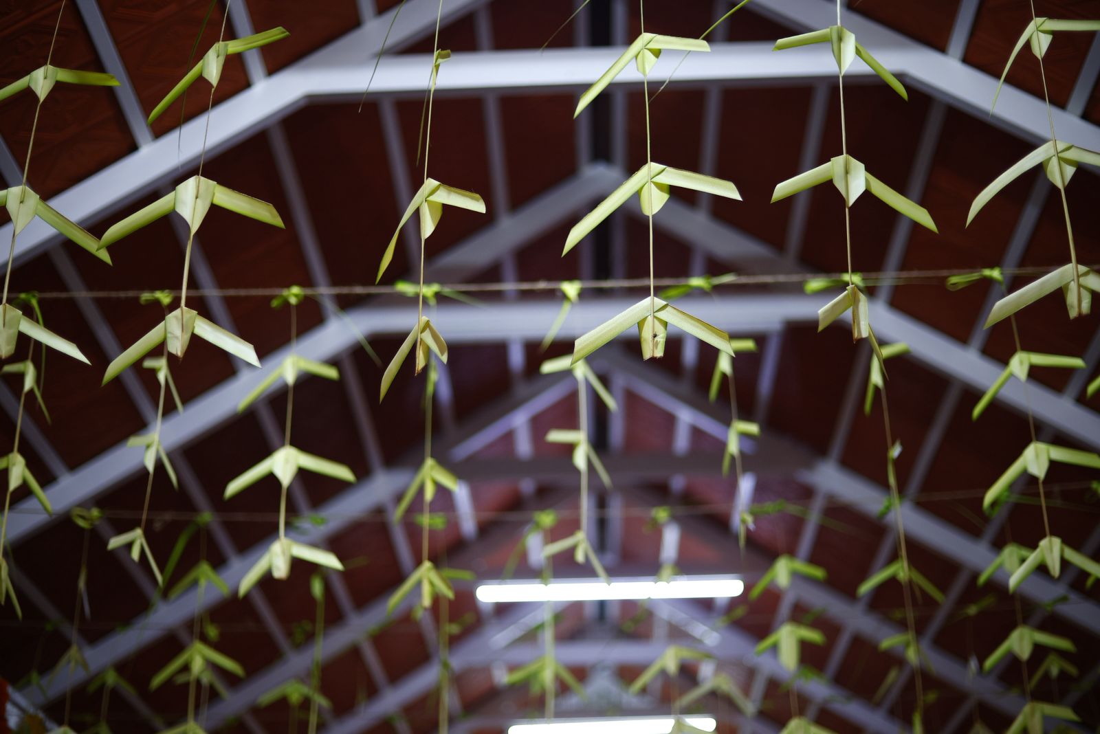 Mango-leaf garlands hanging beneath the maroon ceiling at Sri Bhavani Kalyana Mandira