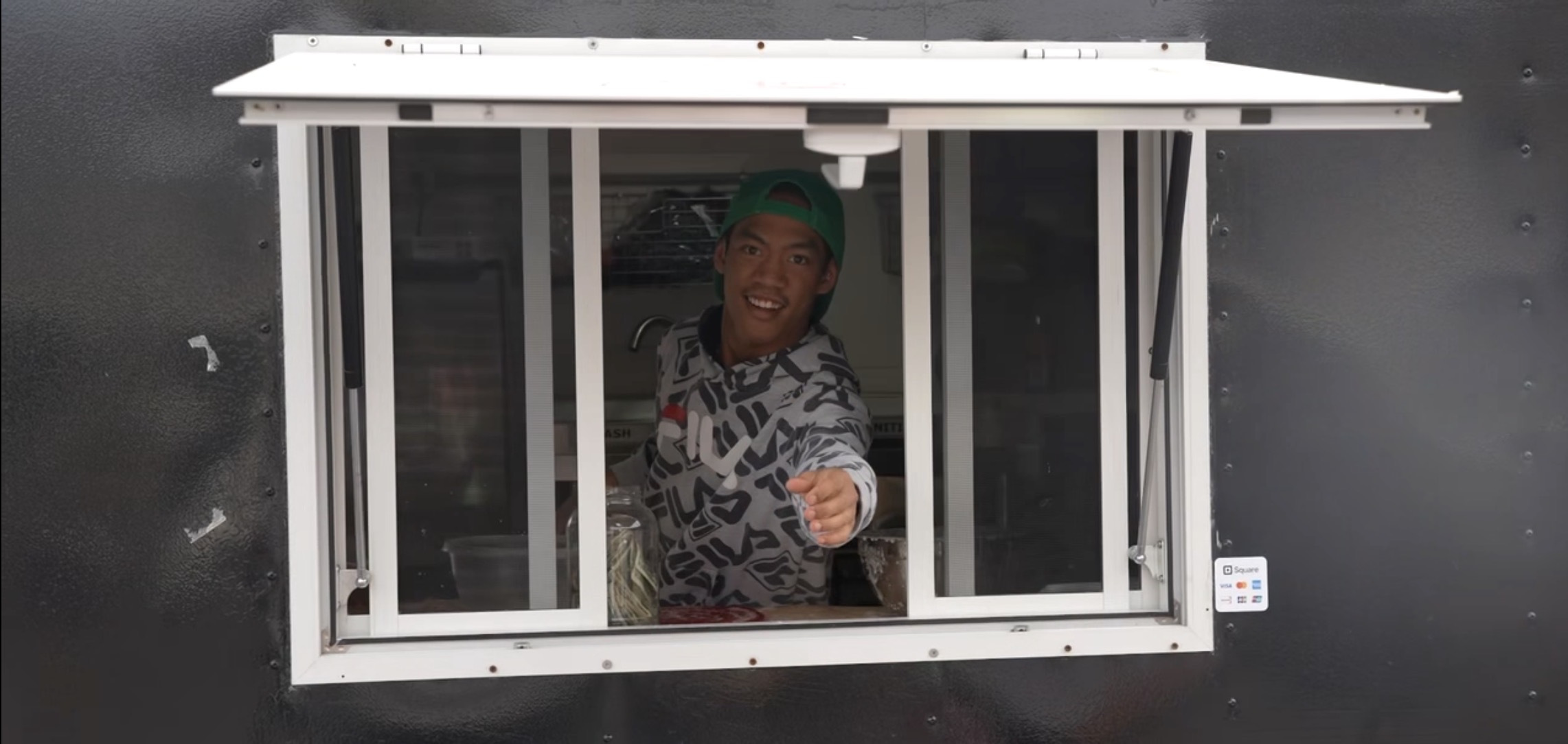 Zach greeting friends from the Bobo's Donuts truck window with his signature smile