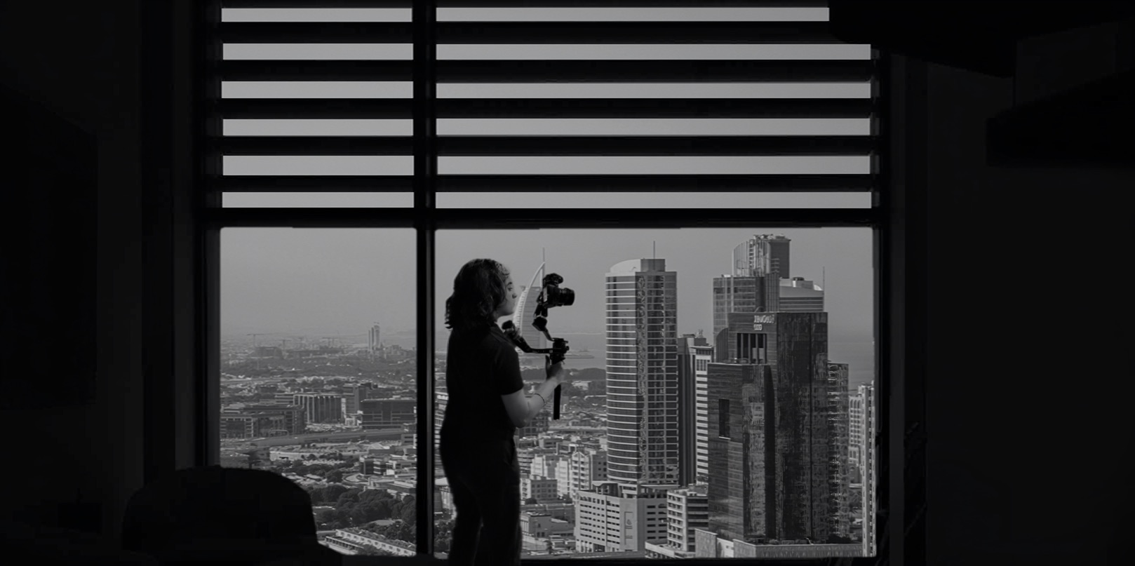 Rida Haider, Founder and Director, Haideri Films — black and white silhouette portrait against Dubai skyline