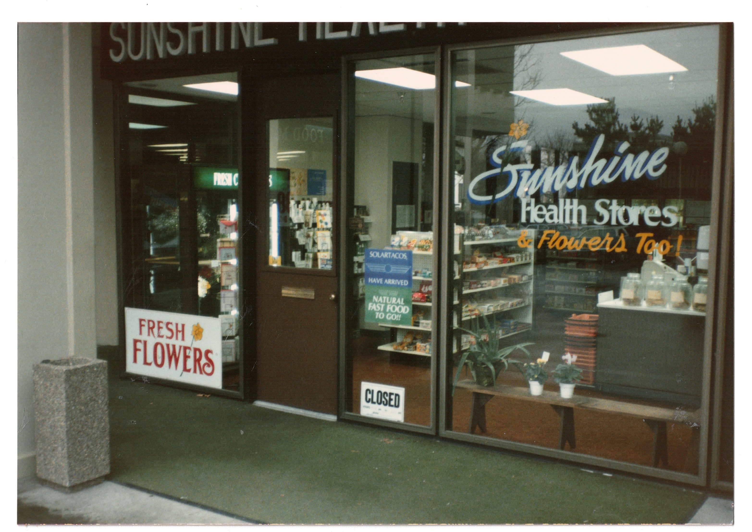 Sunshine Health Stores & Flowers Too! storefront with a CLOSED sign