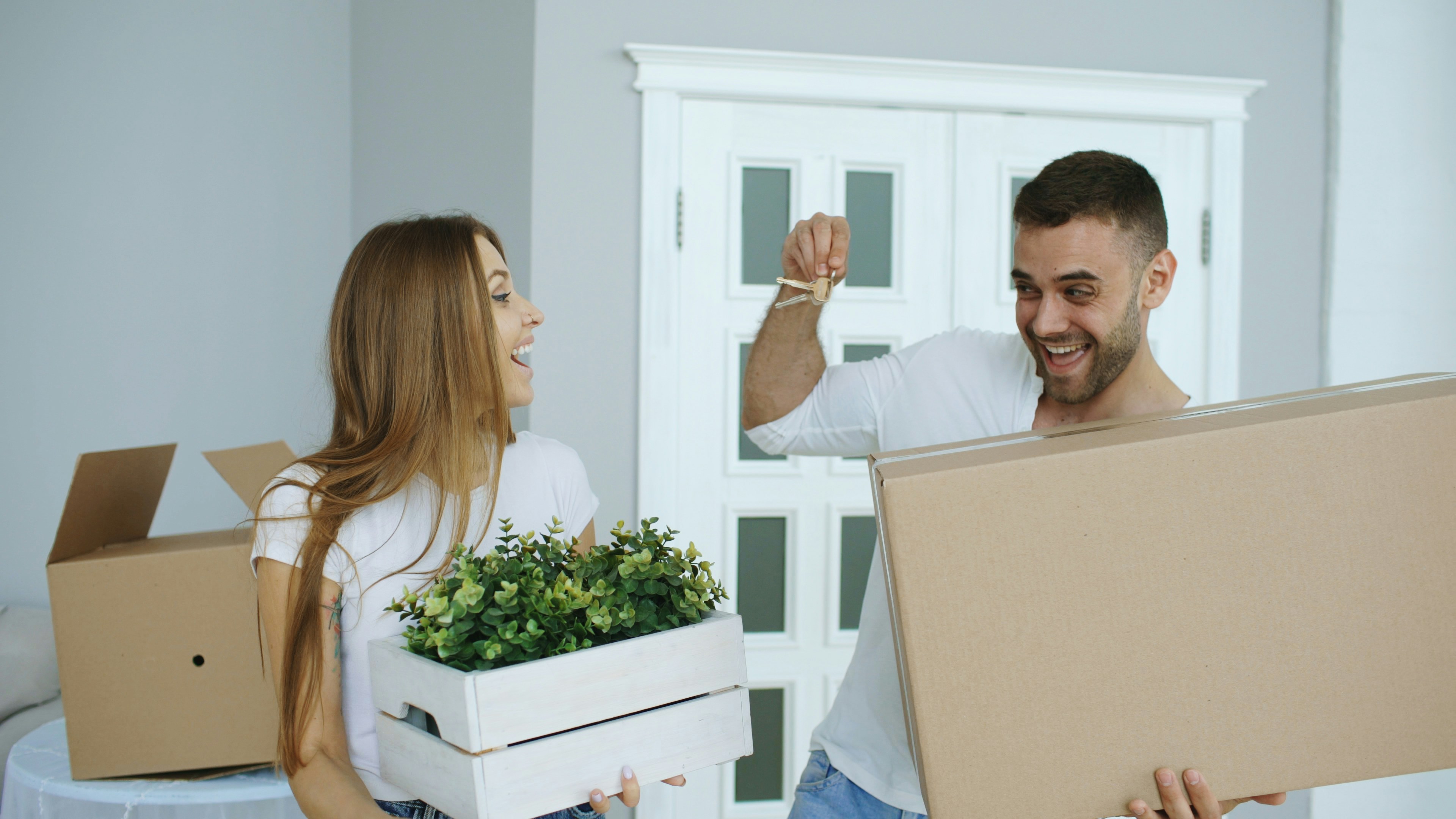 Happy couple with keys to their new home