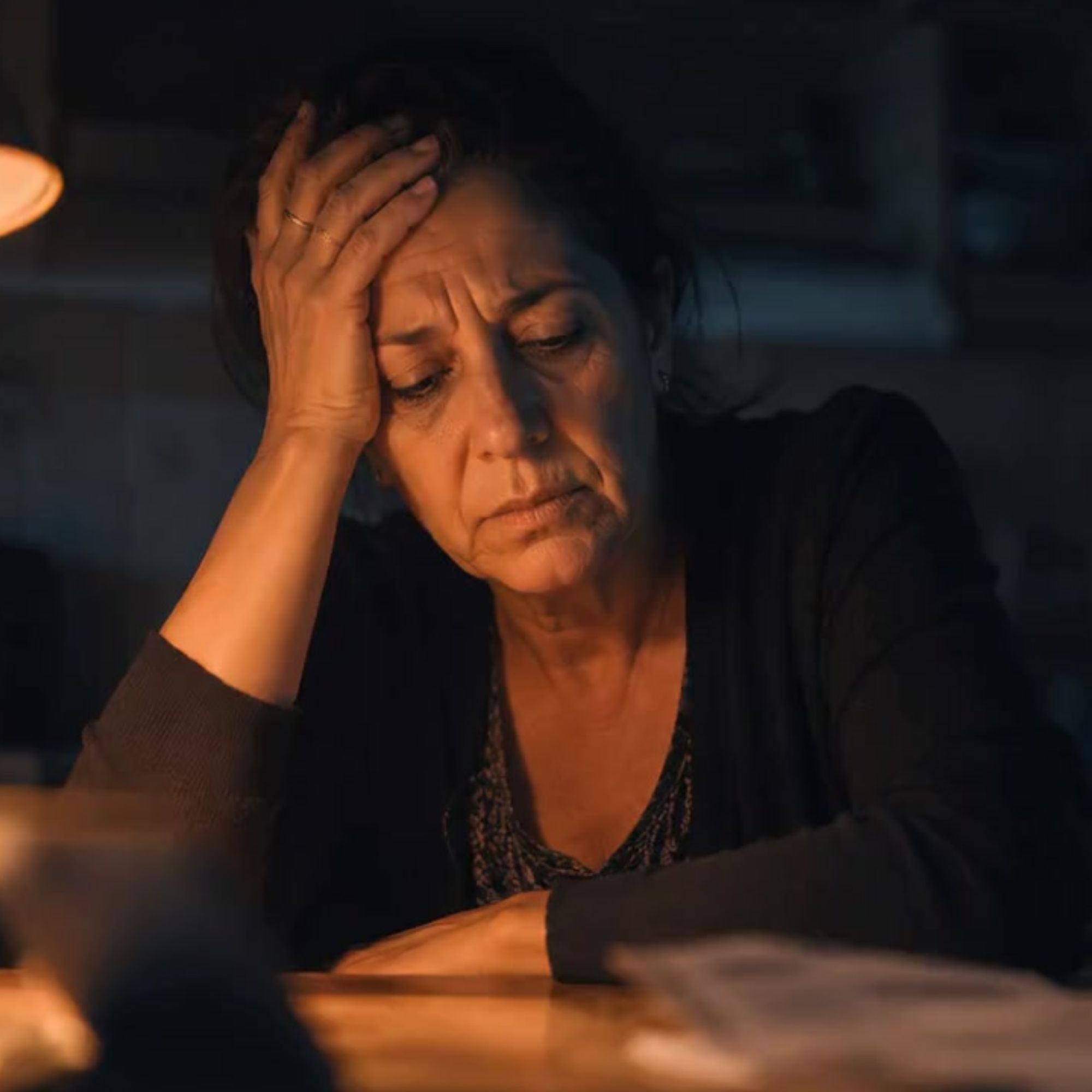 Marilena — una madre nella sua disperazione, illuminata da una lampada nella sera