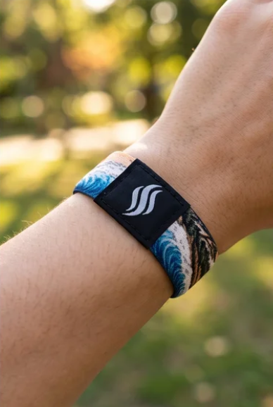 StayScent JP Wave fragrance diffuser bracelet on the wrist outdoors — wearable scent all day