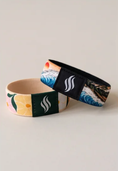 StayScent wearable fragrance bracelets — JP Wave and floral designs with branded scent pad