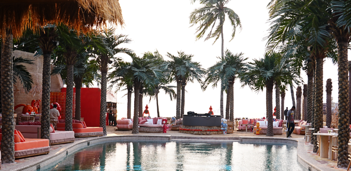 Pool deck framed by palm trees at Bastian Beach Club