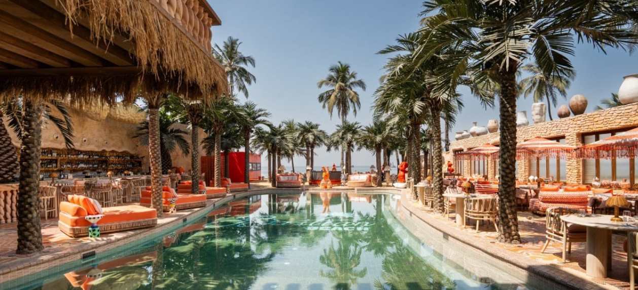 Bastian Beach Club — pool, palm trees and Arabian Sea view