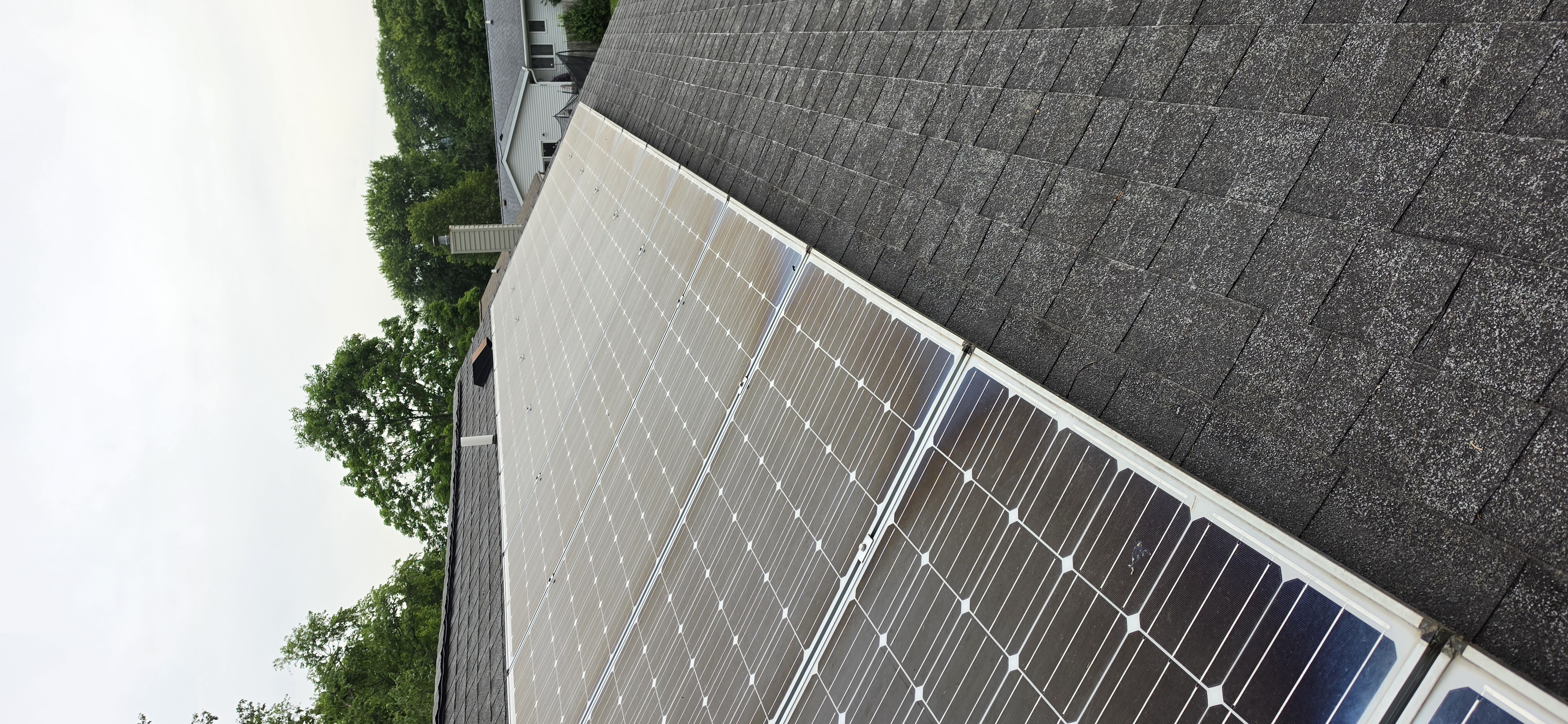 Solar panels after 8 years without a professional cleaning — hazy, milky film across every cell from stacked seasons of pollen, hard-water residue, and airborne particulate
