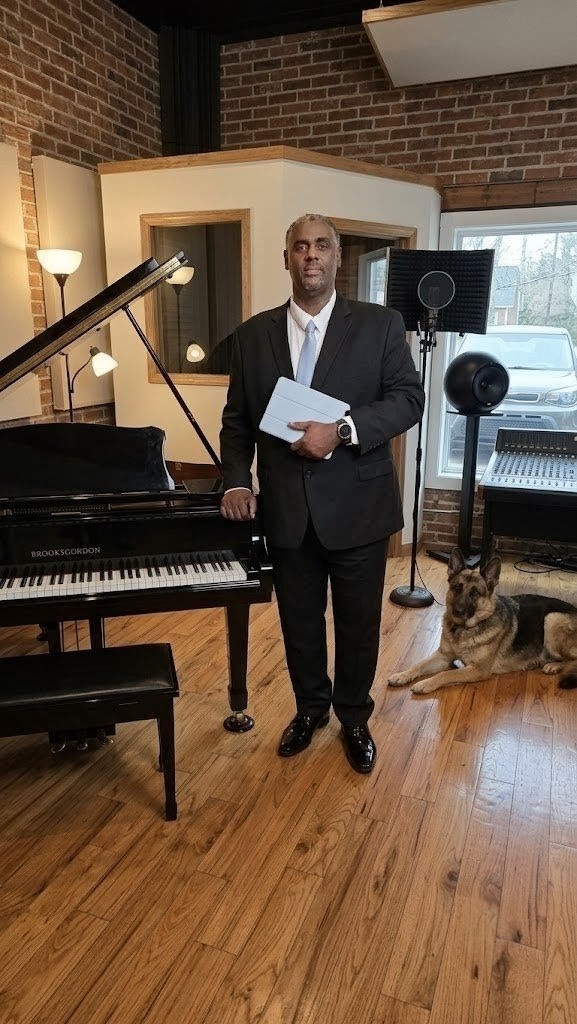 Brooksgordon at his studio piano with his German Shepherd
