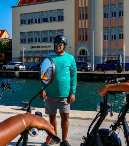 Trevor Nisbeth — Operator & Business Development Manager at E-Wheels Experience, by the Willemstad waterfront