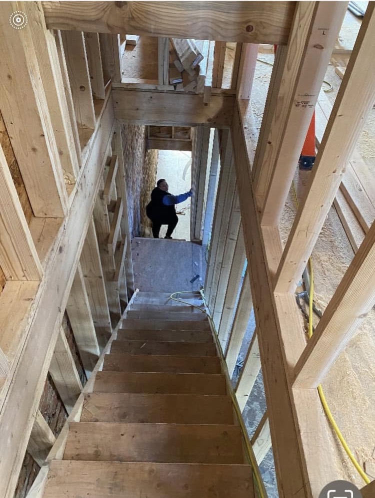 A Dorsey Taylor Homes property mid-rebuild — framing and lumber stage