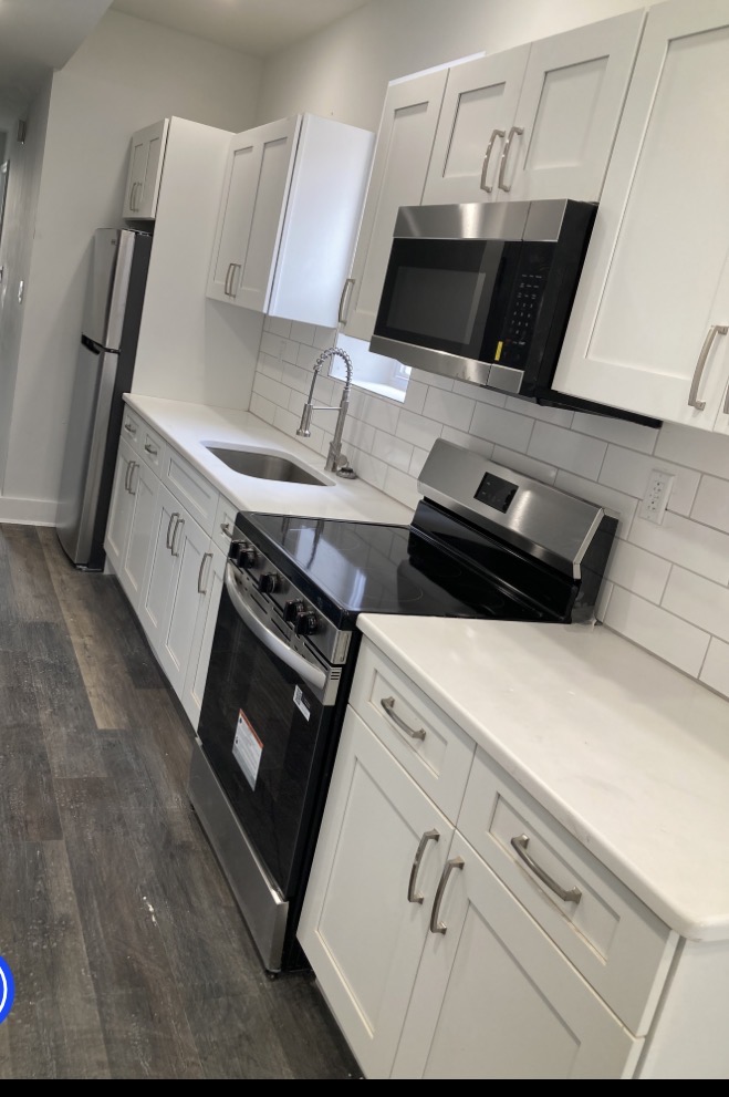 A finished Dorsey Taylor Homes kitchen — white shaker cabinets, subway tile, stainless appliances