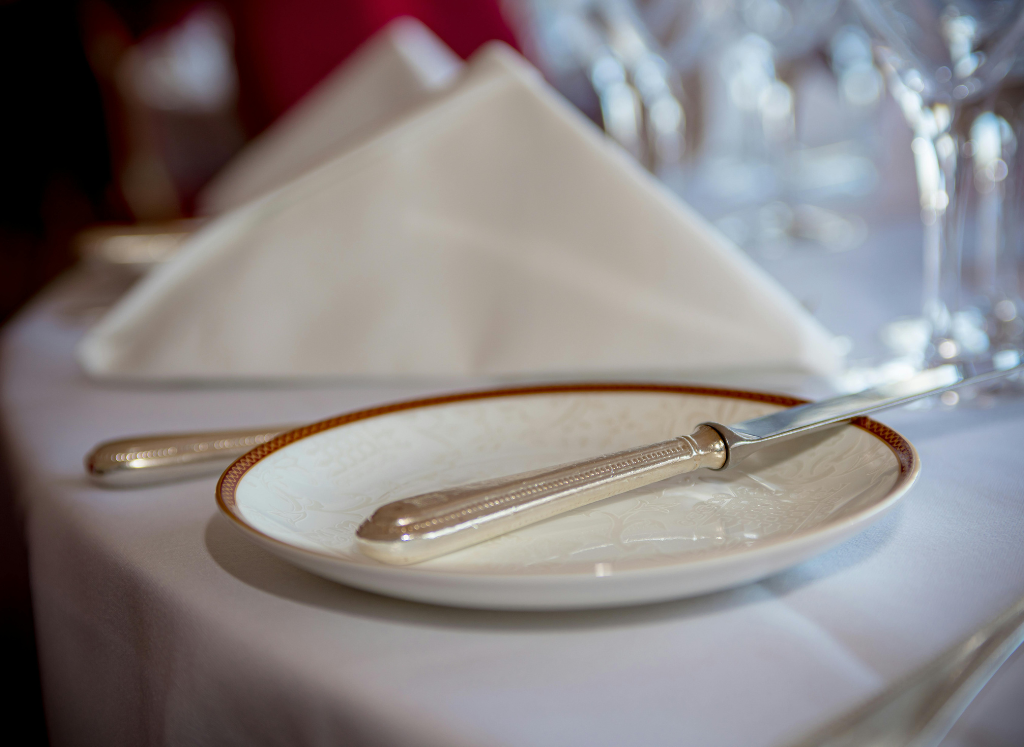 Elegantly folded napkin standing beside crystal glassware