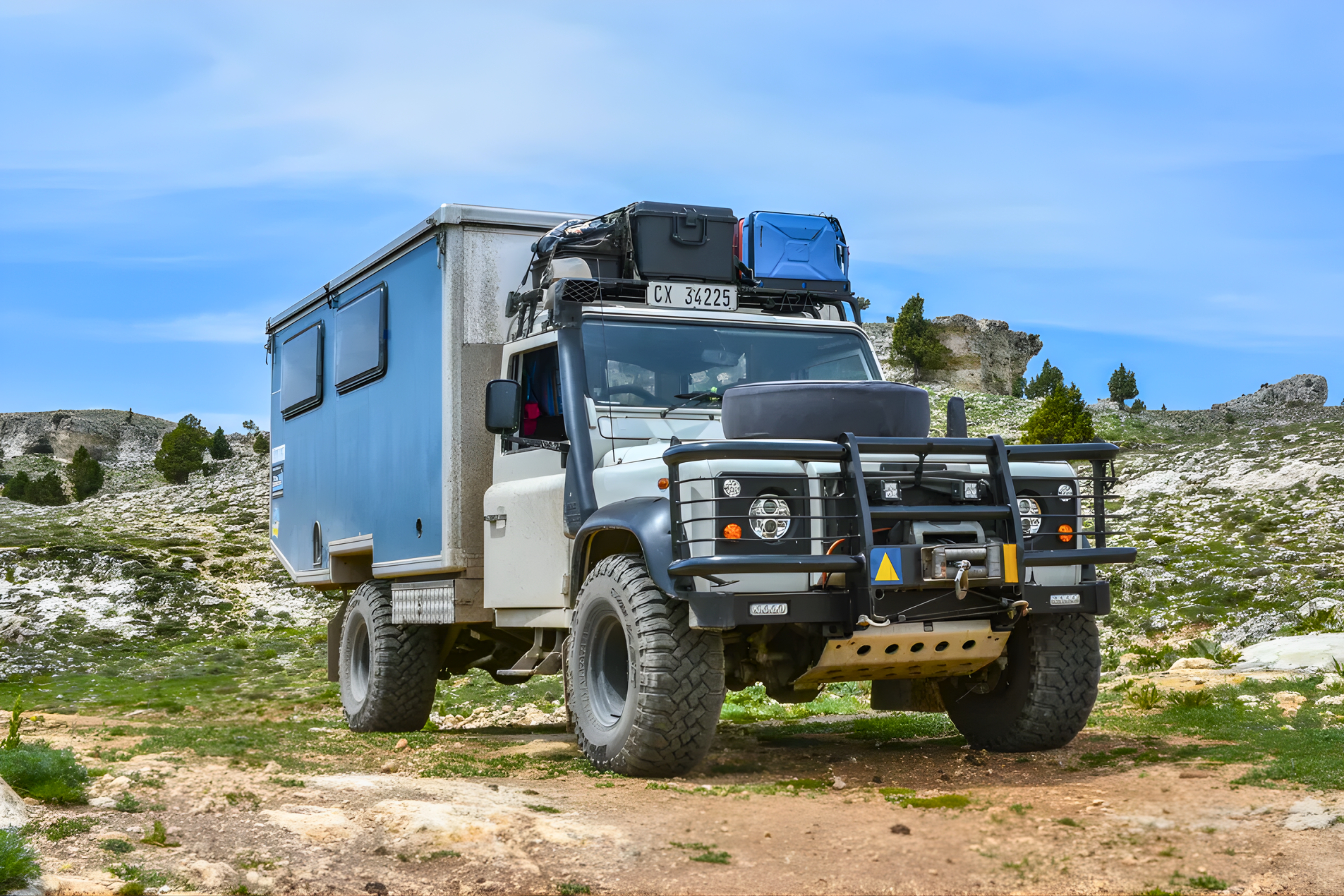 Custom build on Land Rover Defender 130 — rocky mountain terrain