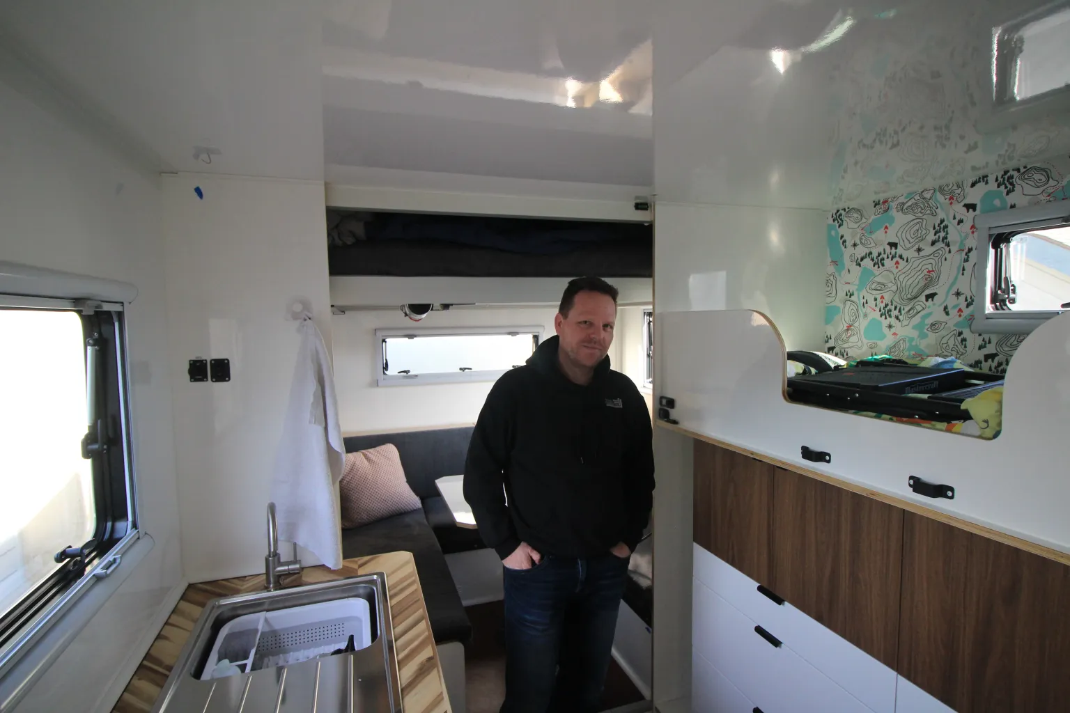Andreas Schwall inside a Total Composites camper interior