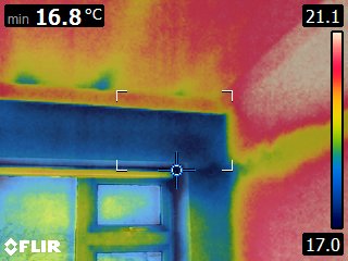 Thermal imaging of the window head and lintel junction showing reduced surface temperatures compared with the surrounding wall. The colder band indicates increased heat transfer through the window opening and highlights an area requiring further investigation.