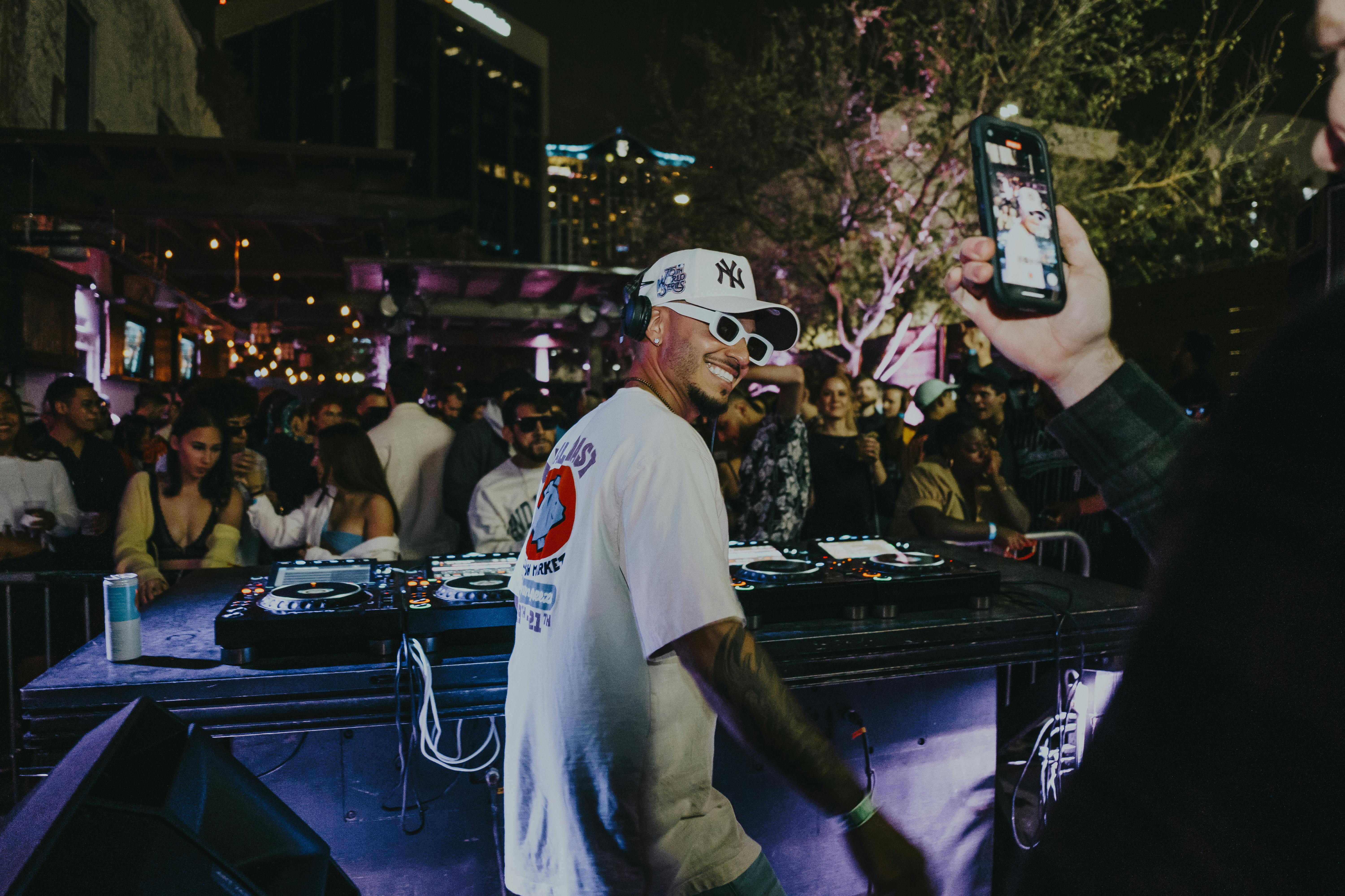 DJ performing at outdoor event with crowd