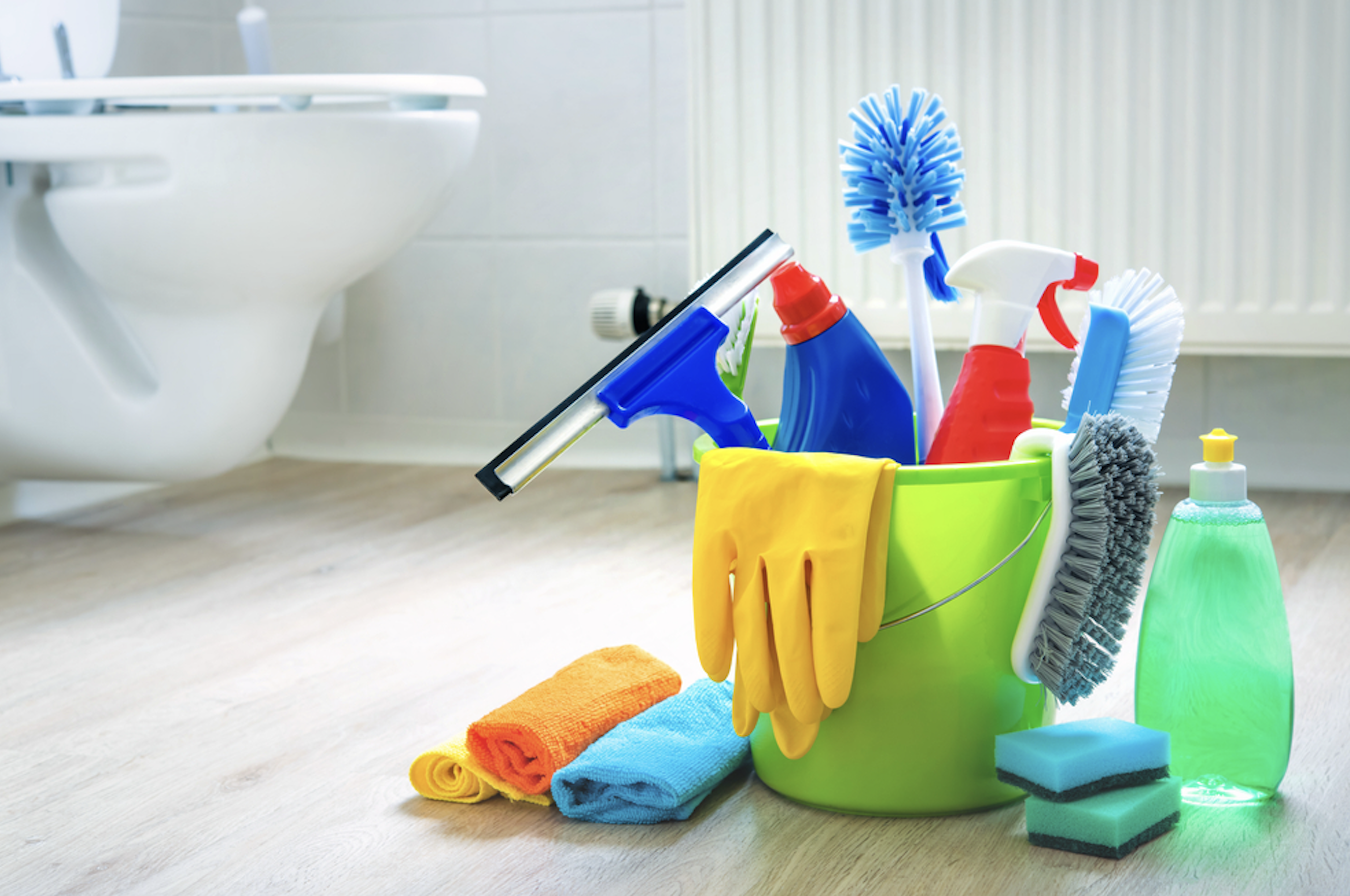 Deep Clean technician cleaning a commercial restroom stall with professional equipment