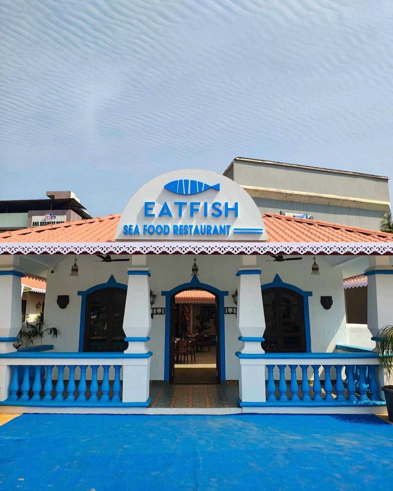 EATFISH Alibag — coral-tiled façade at golden hour