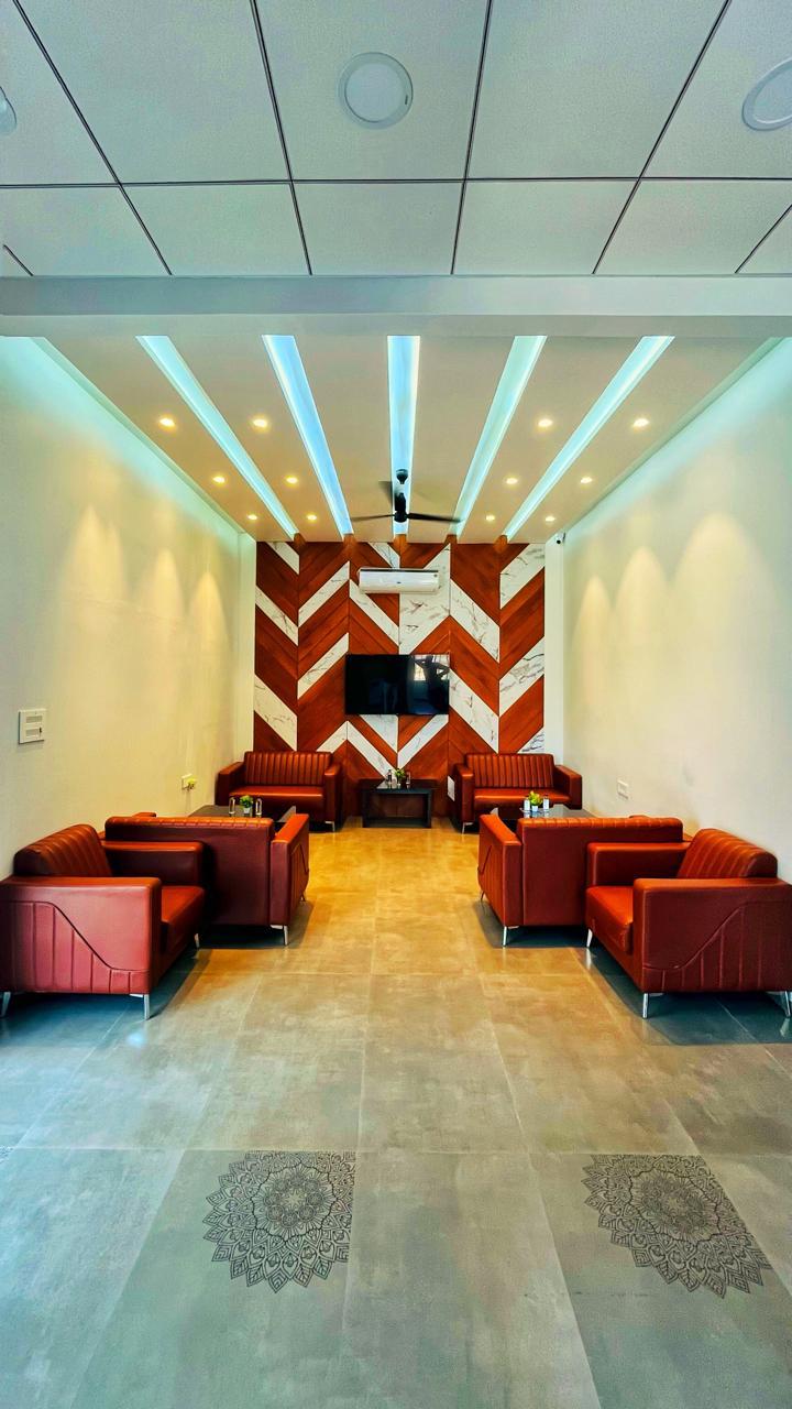 Waiting lounge — chevron feature wall, terracotta upholstery