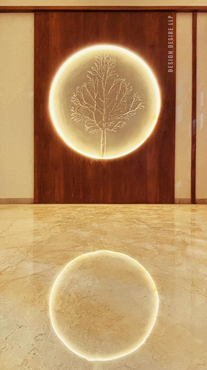 Signature detail — hand-etched tree in a backlit oval reveal