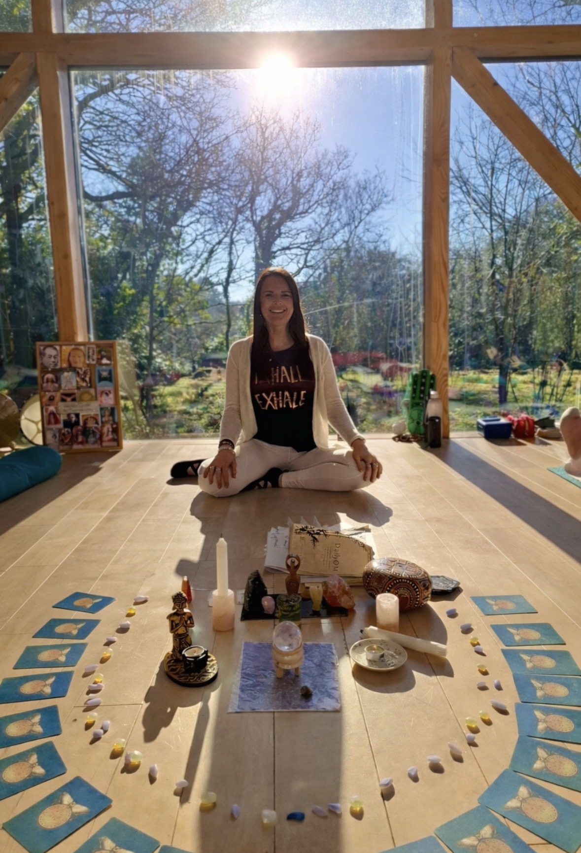 Annelie Lily leading a women's circle ceremony with sacred altar, crystals, candles and oracle cards in a sunlit space