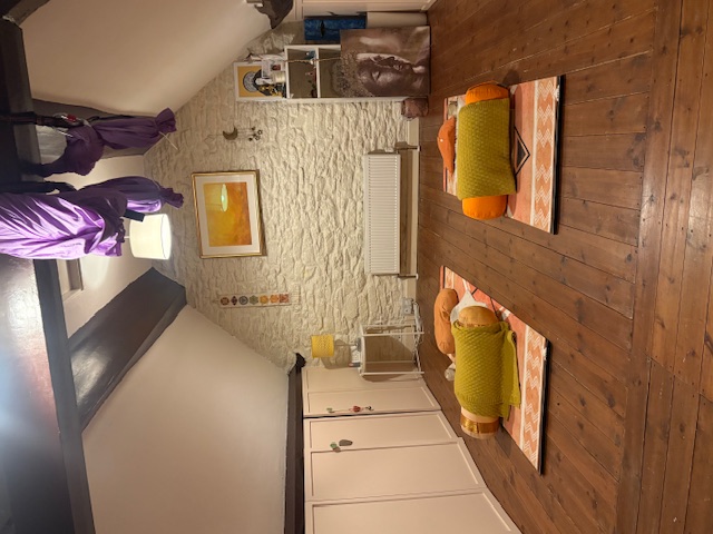 Annelie Lily's private yoga studio in Frome with yoga mats, bolsters and aerial silks in a cosy converted loft space