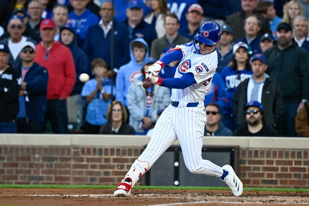 Chicago Cubs batter swinging at pitch with crowd in background