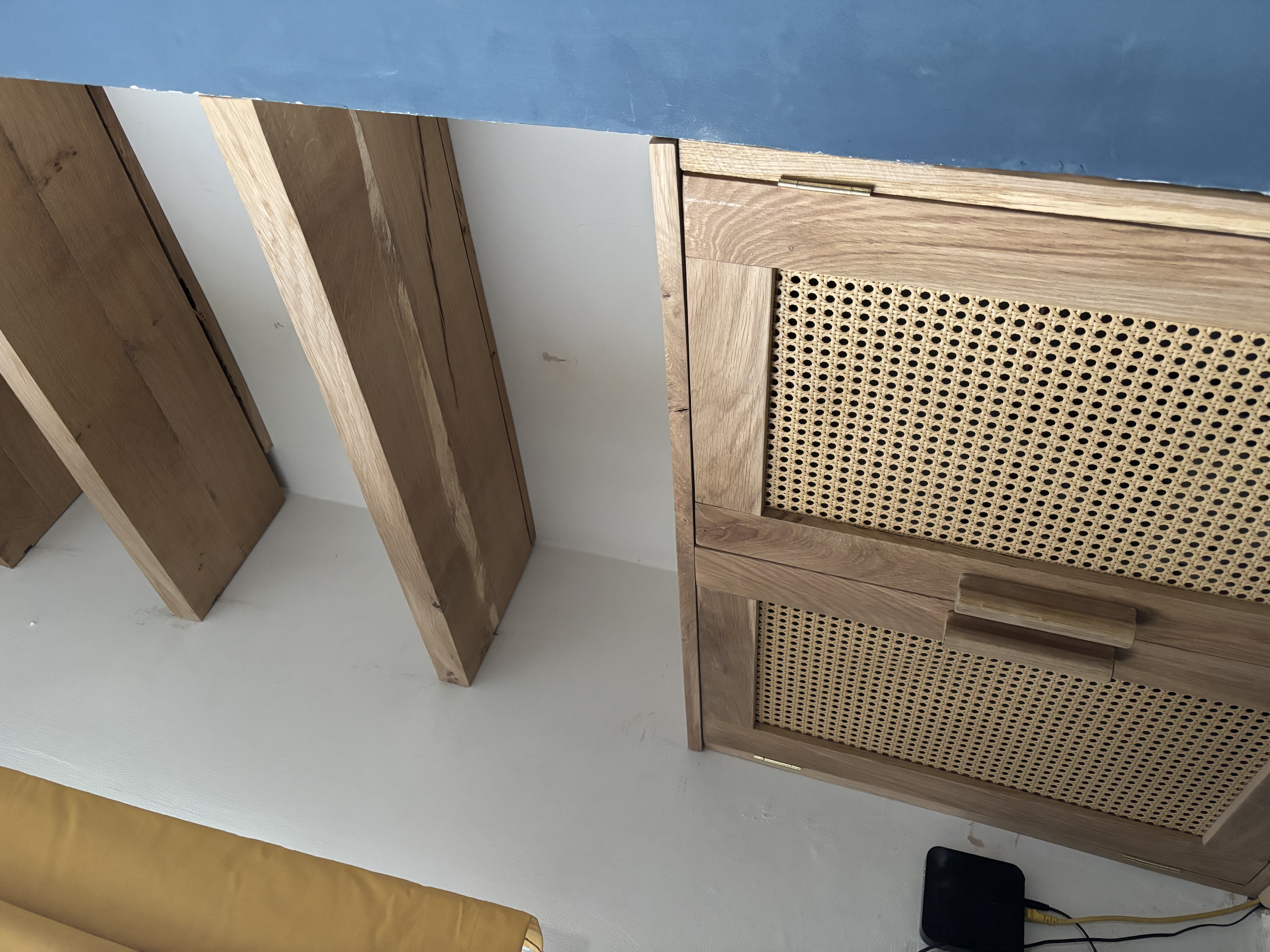 Custom built-in shelving with rattan cabinet