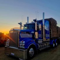 McDonald Trucking blue Kenworth prime mover at sunset