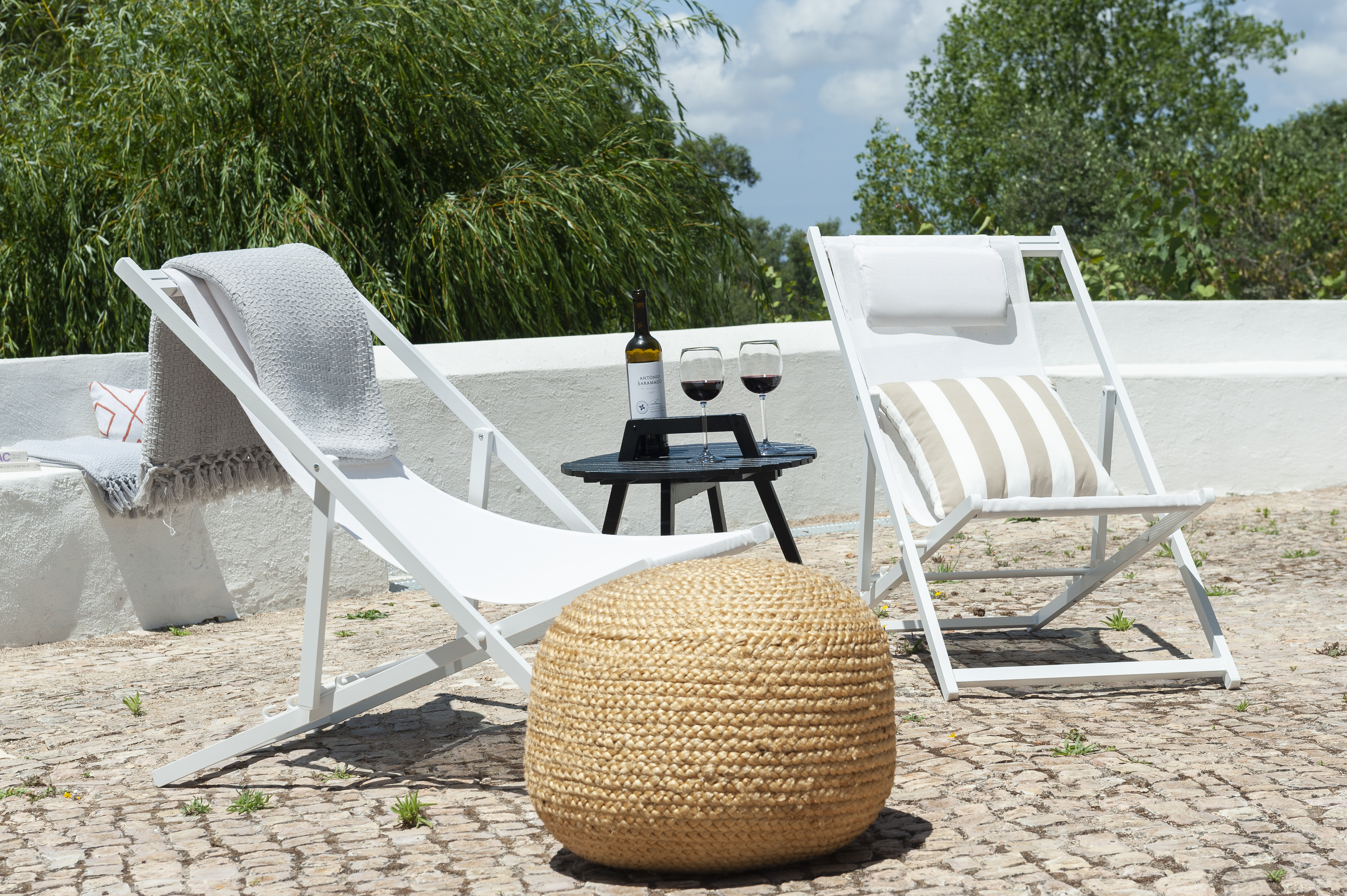 Pine Tree House deck chairs with wine