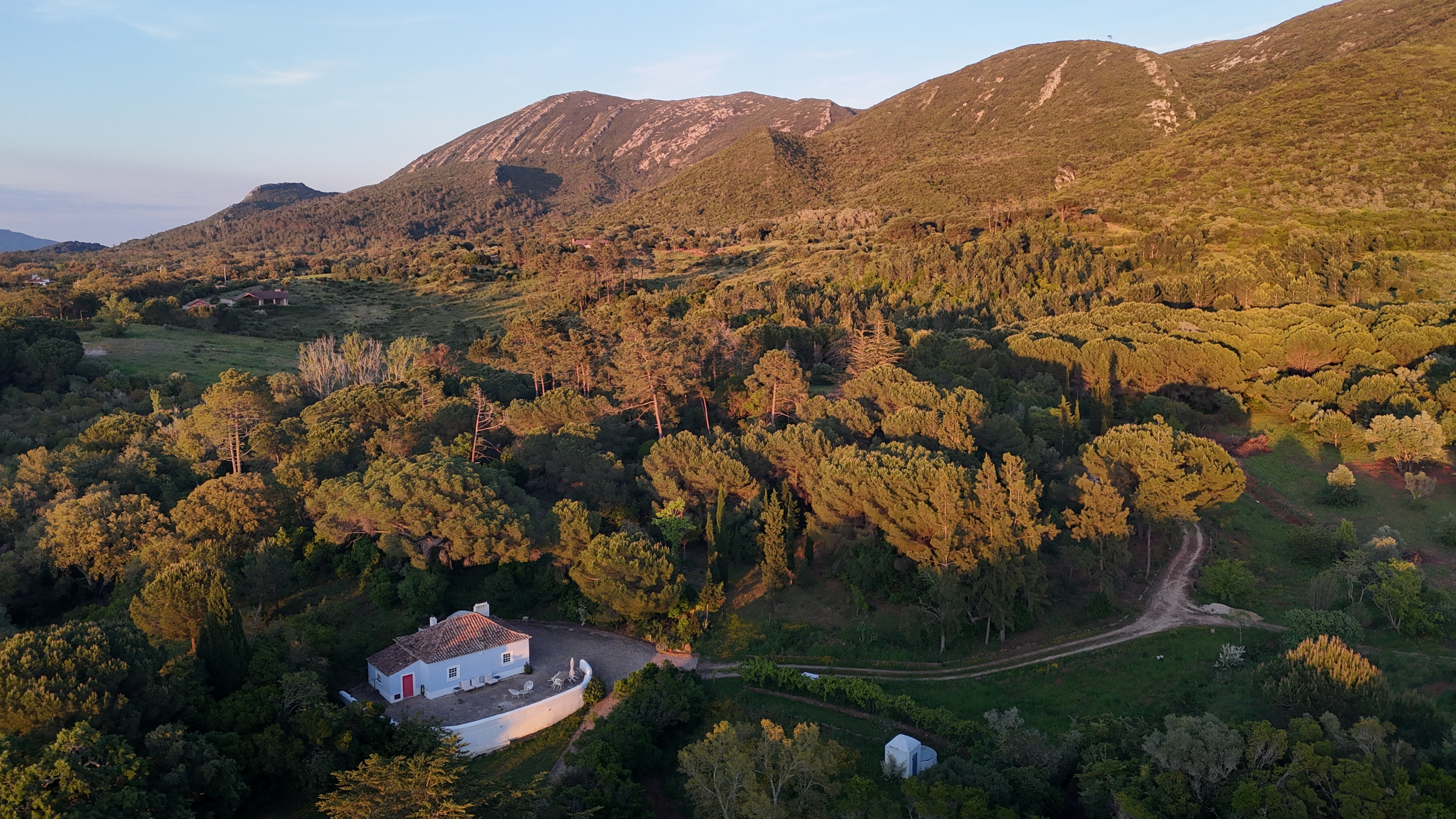 Pine Tree House aerial view with Arrábida mountains at sunset