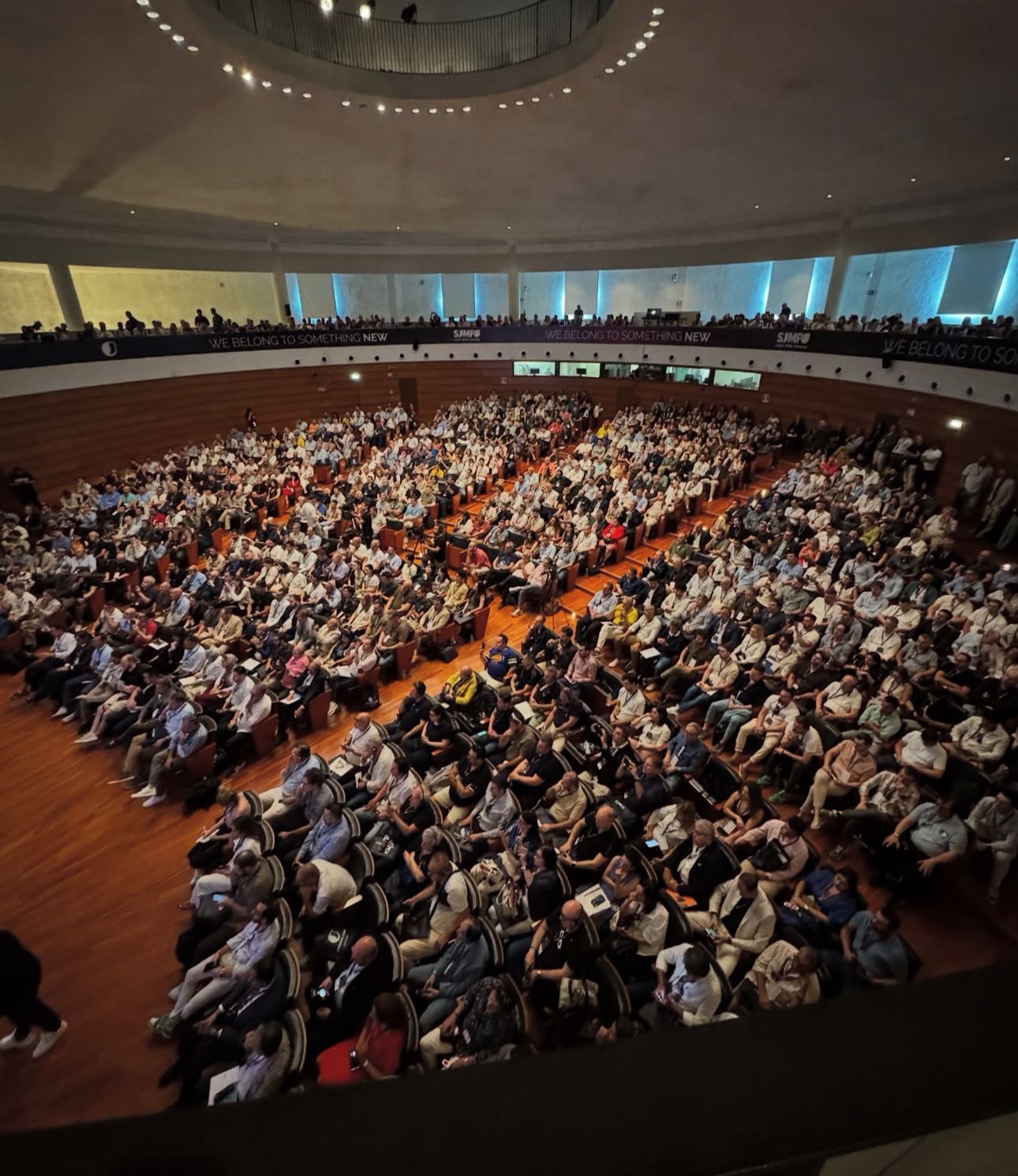 Dr. Simon Oh speaking to a packed conference auditorium