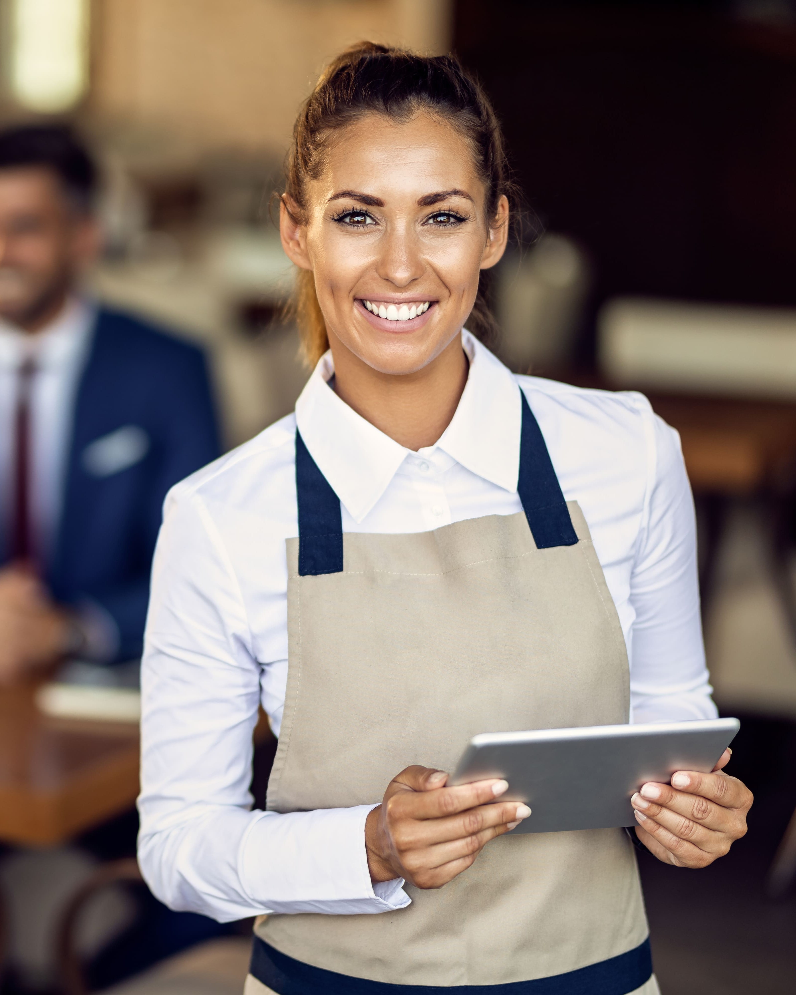 Professionnelle CHR souriante avec sa tablette