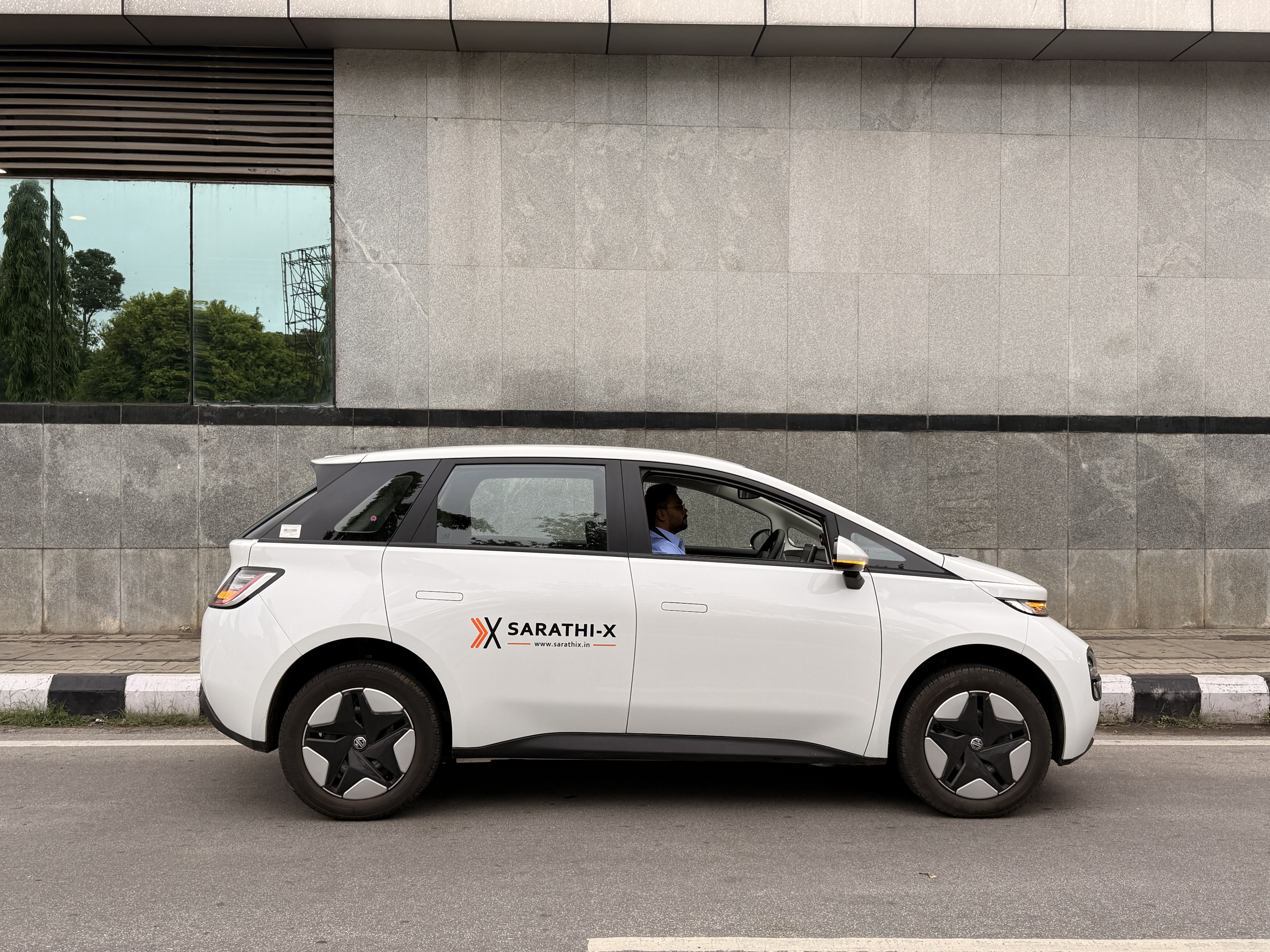 Sarathi-X MG Windsor EV side profile with Sarathi-X branding on the door
