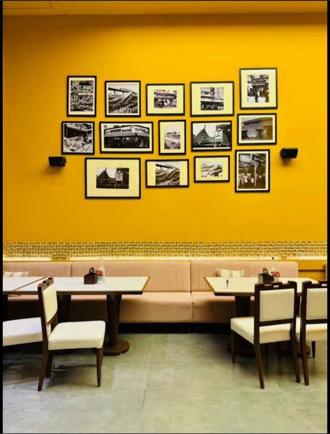 Gallery wall with black-and-white photos on mustard yellow