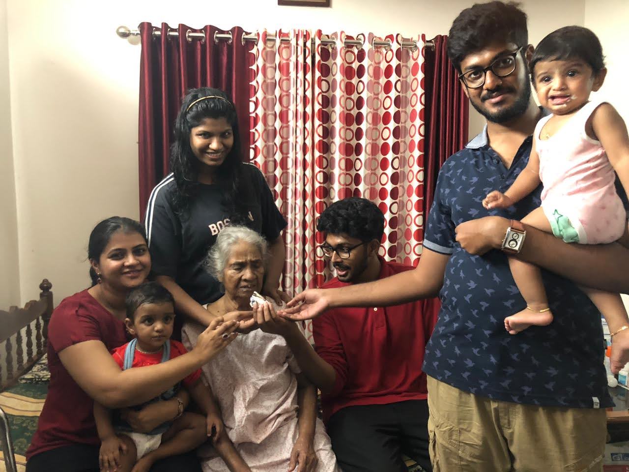 Four generations in one frame — grandmother, children, and the little ones.