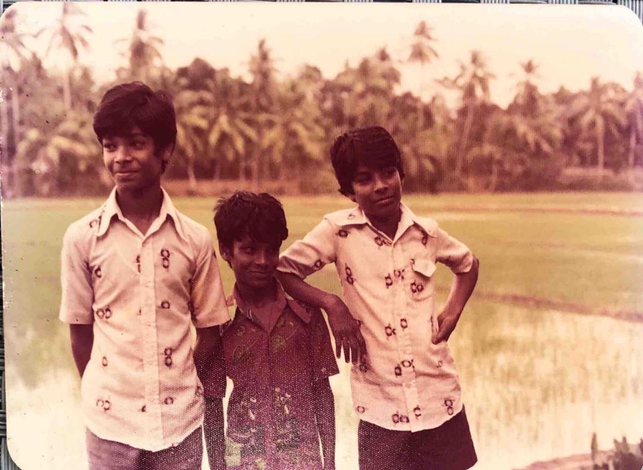Three boys by the paddy fields — a glimpse of boyhood in Kerala.