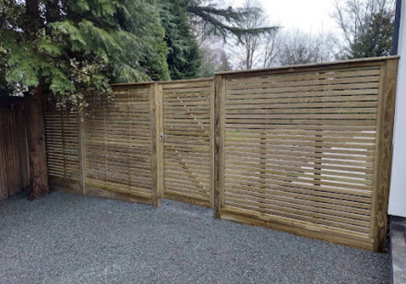 Contemporary slatted timber fence panels