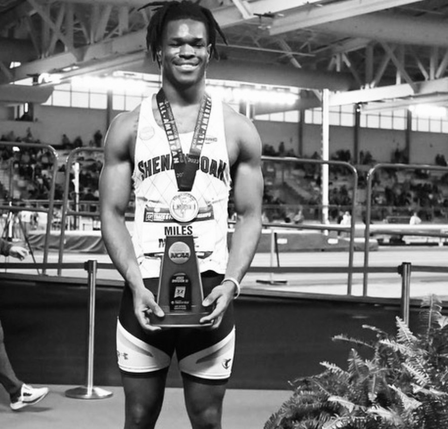Athlete with NCAA All-American trophy