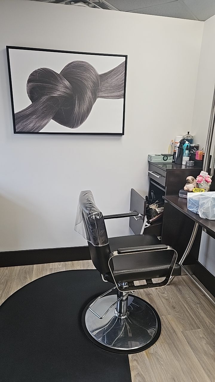 Stylist chair with hair art on wall