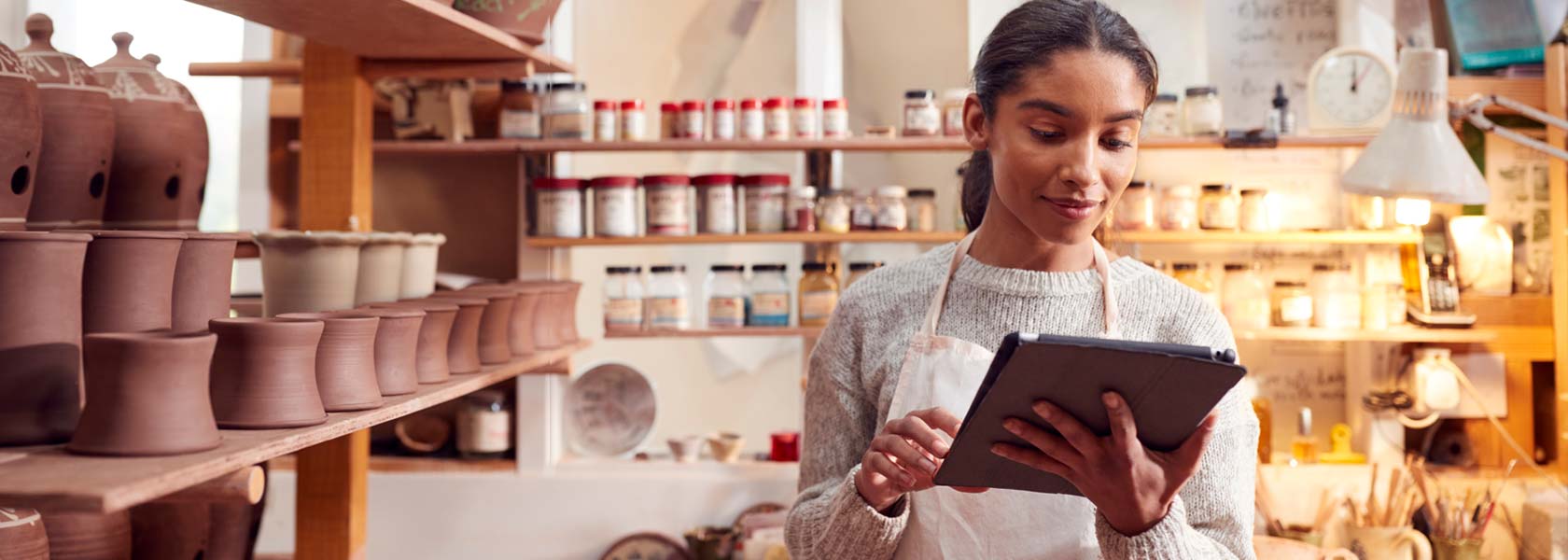 Small-business owner managing her shop on a tablet