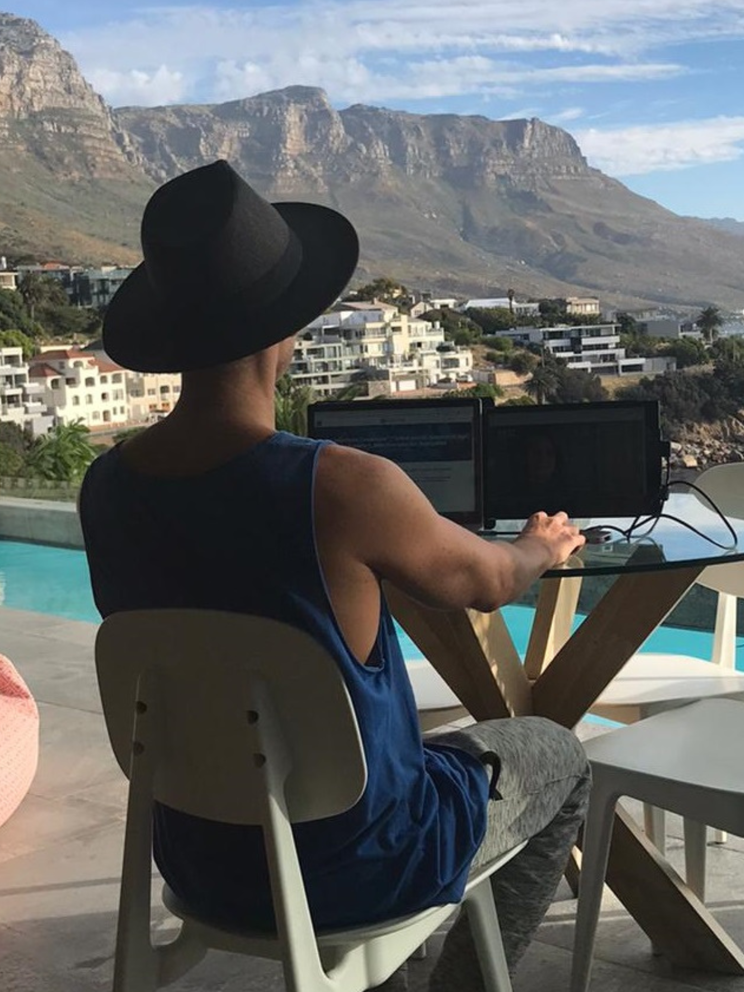 Digital nomad working by the pool