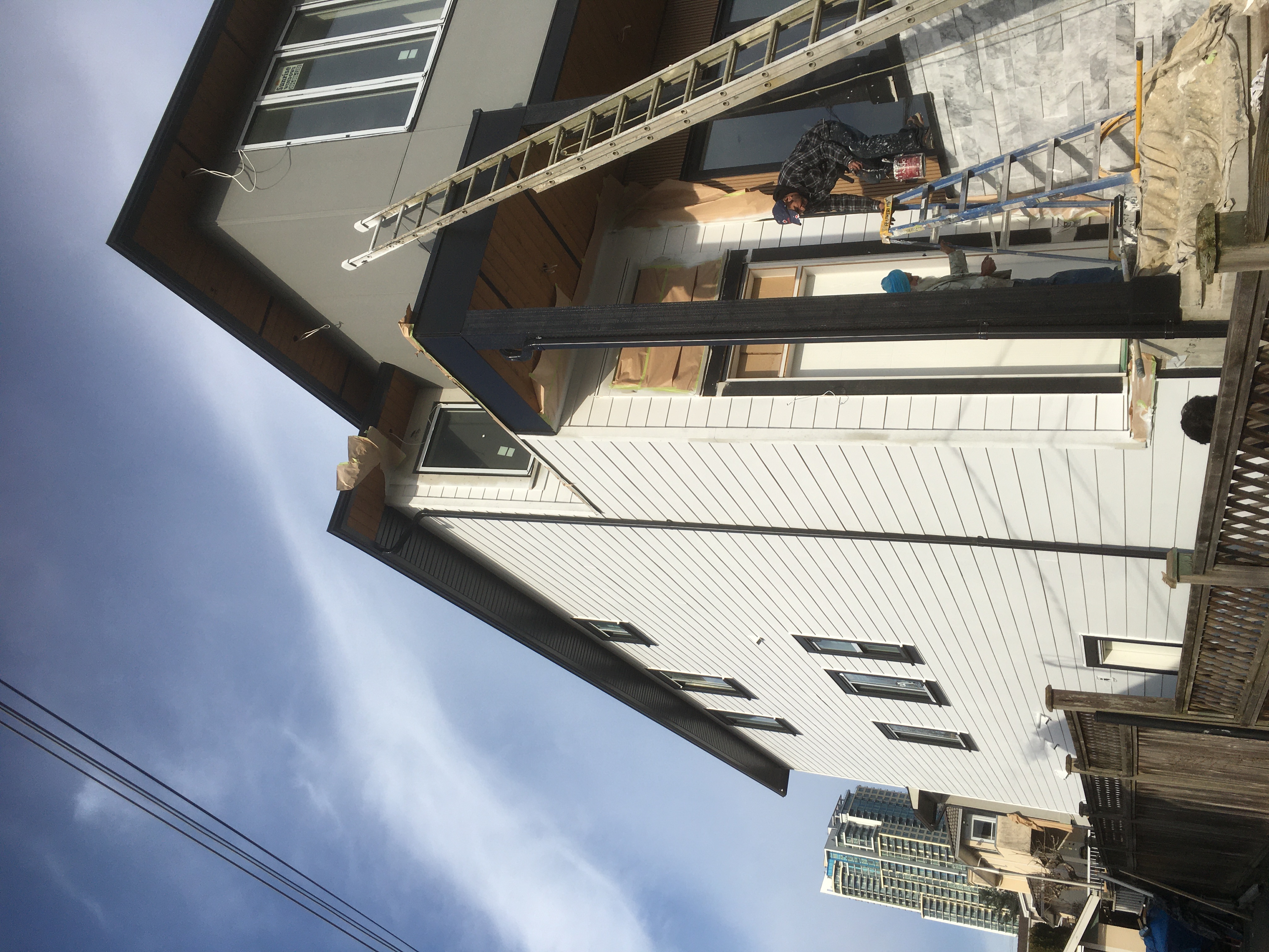 New construction exterior painting - White siding with dark trim