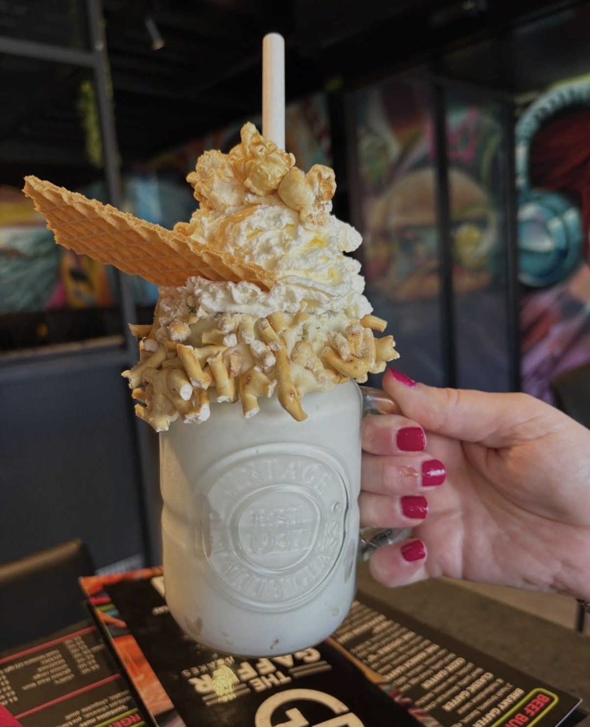 Thick shake topped with waffle, pretzels and popcorn