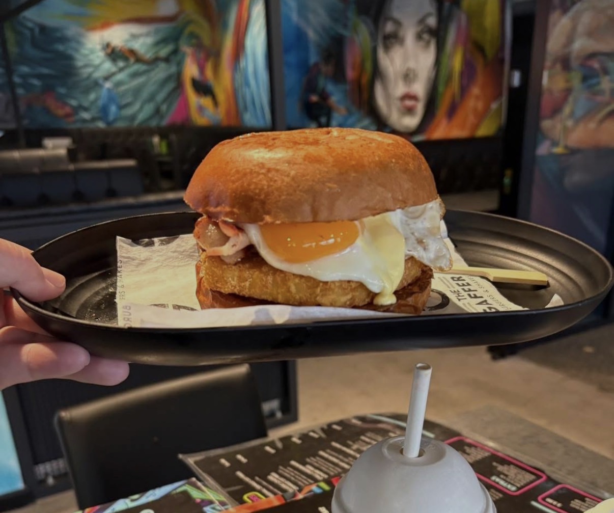 Brioche burger with hash brown and runny fried egg