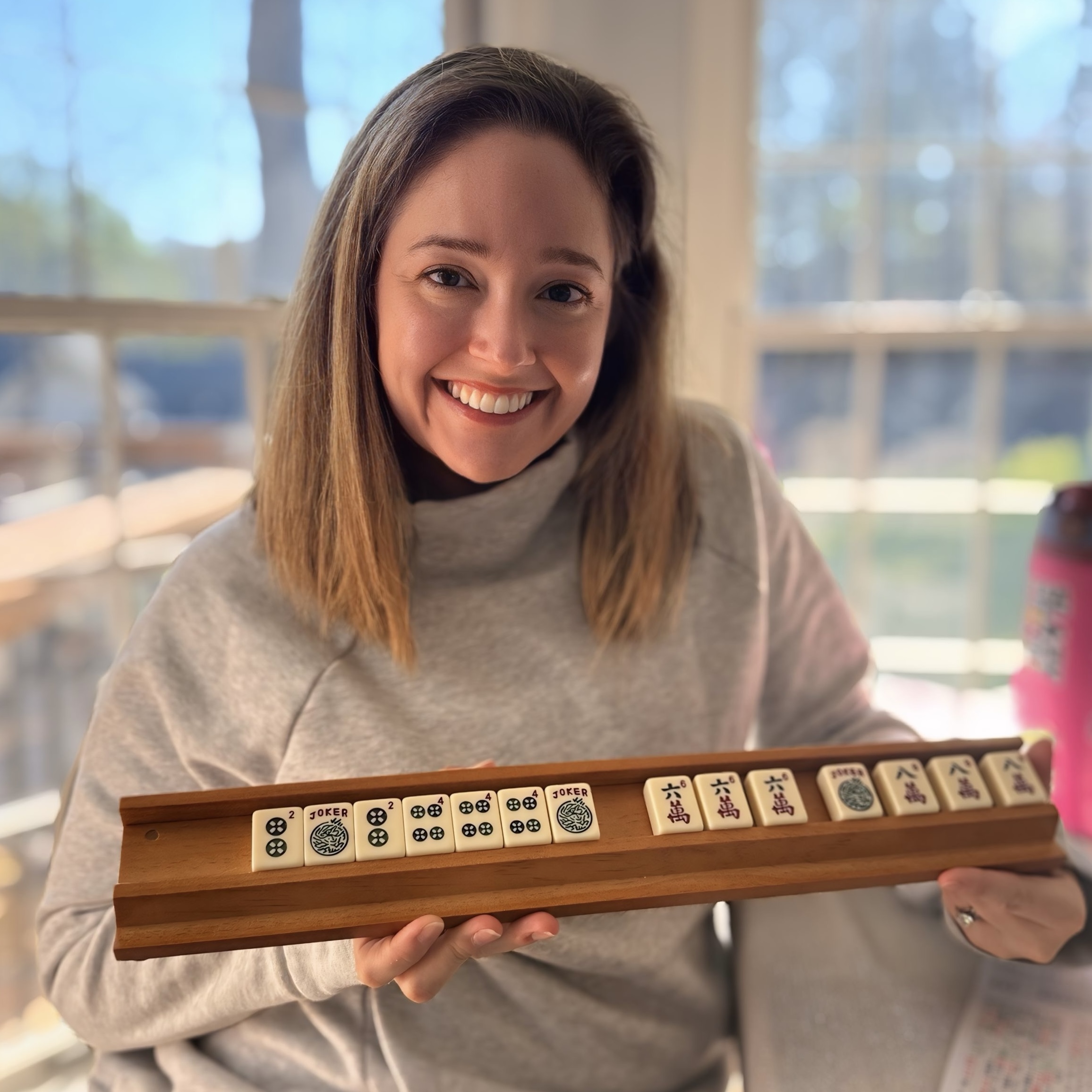 Rachel holding her American Mahjong rack