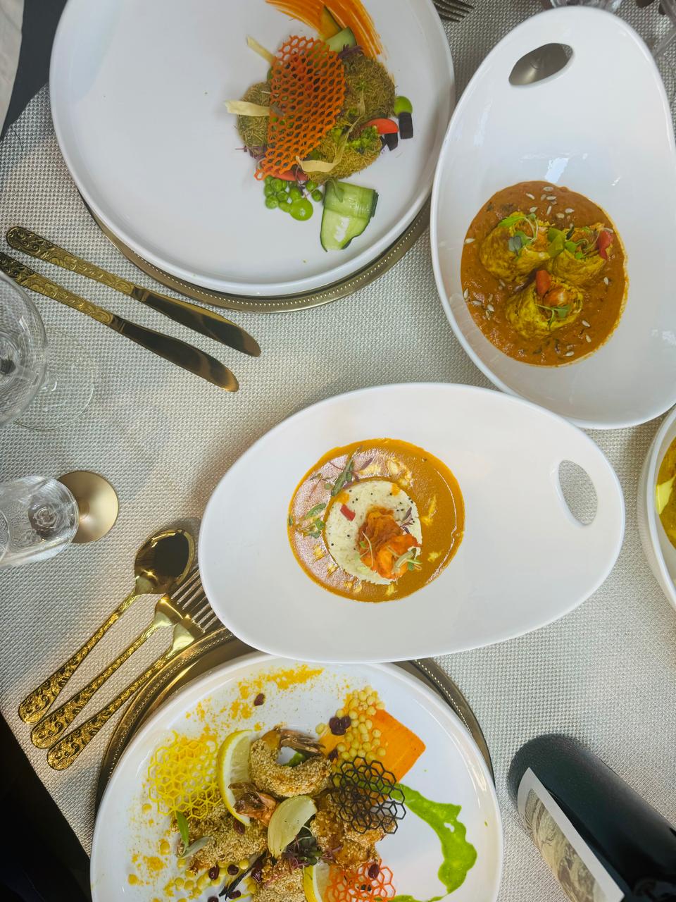 Gourmet dishes with gold cutlery